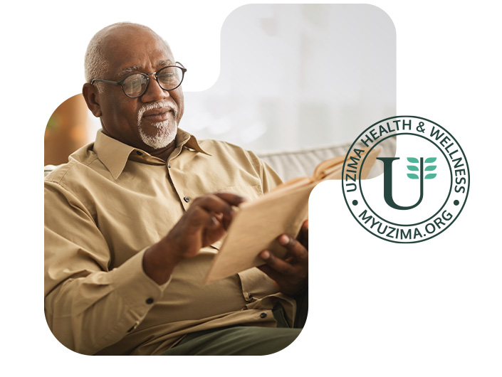 Elderly Black man reading a book reviewed and recommended by UZIMA Health & Wellness